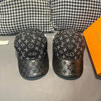 Pair of Louis Vuitton monogram caps with dark fabric and repeating LV motifs