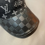 Louis Vuitton cap brim detail with dark check pattern and stitched trim