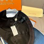 Louis Vuitton cap with black interior lining and hanging price tag