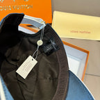 Blue Louis Vuitton cap with product tags attached and inner panel visible.