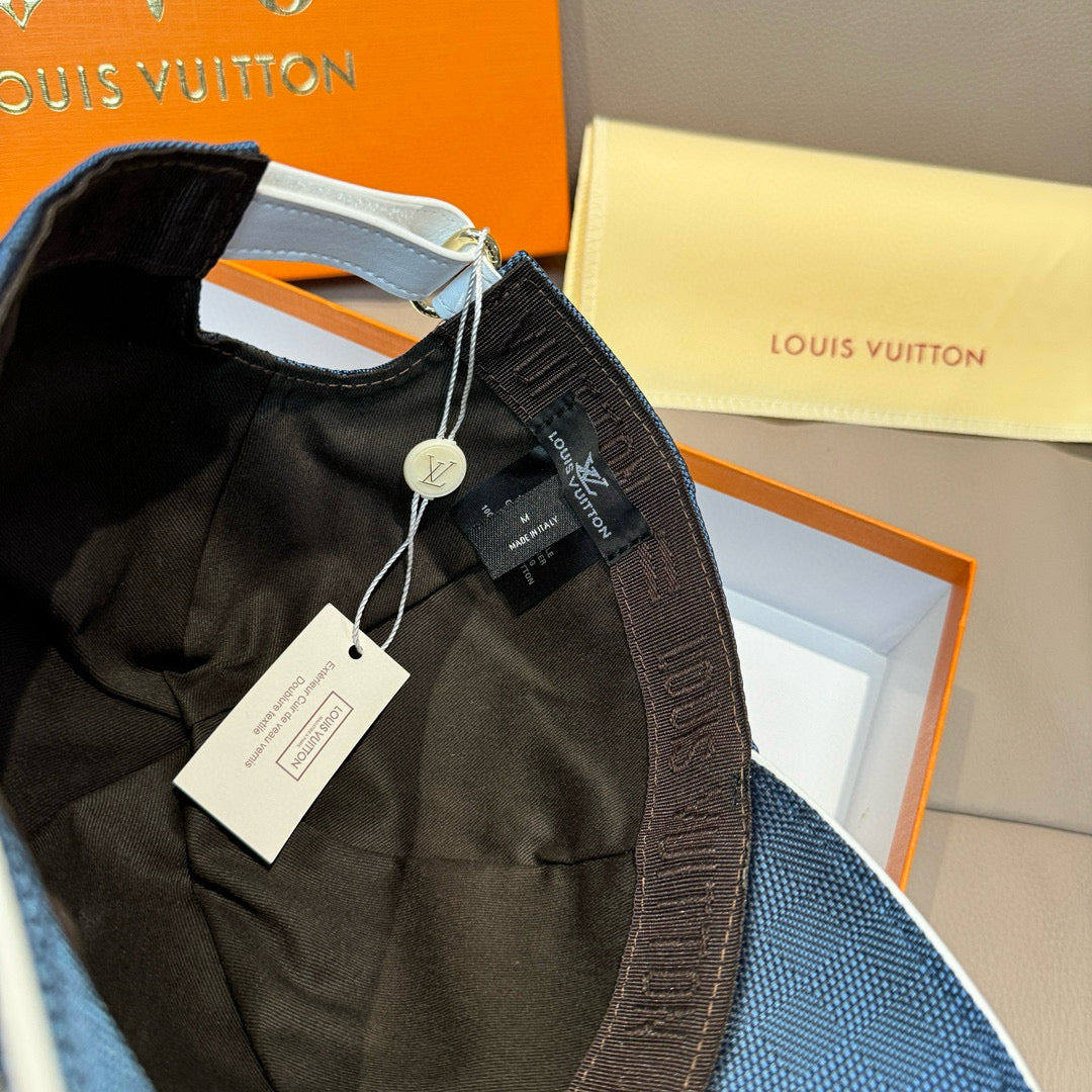 Blue Louis Vuitton cap with product tags attached and inner panel visible.