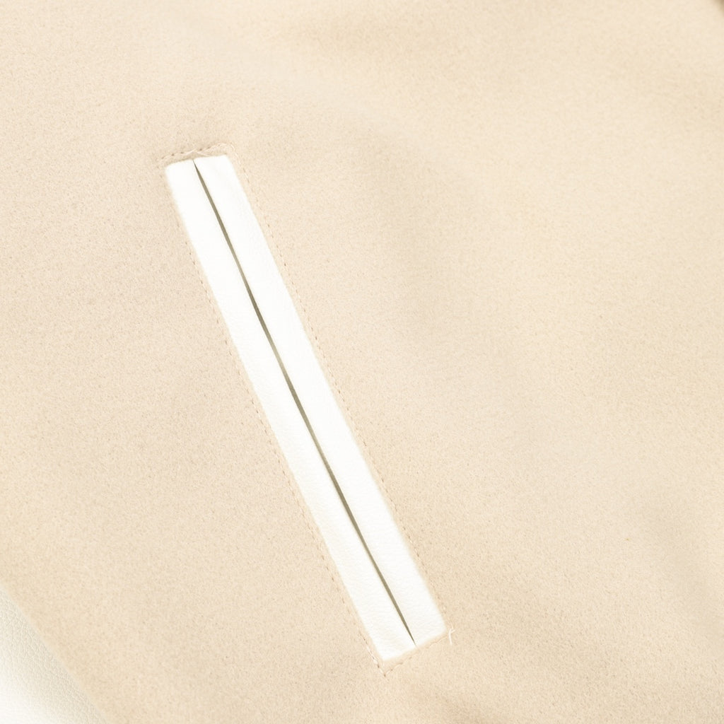Beige bomber jacket sleeve with slim white stripe accent