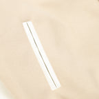 Beige bomber jacket sleeve with slim white stripe accent