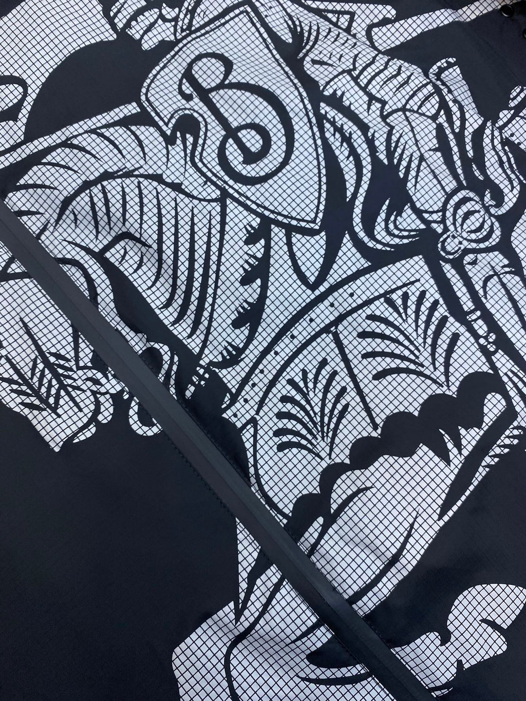 Hooded jacket graphic print close-up on dark fabric