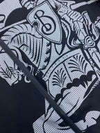 Hooded jacket graphic print close-up on dark fabric