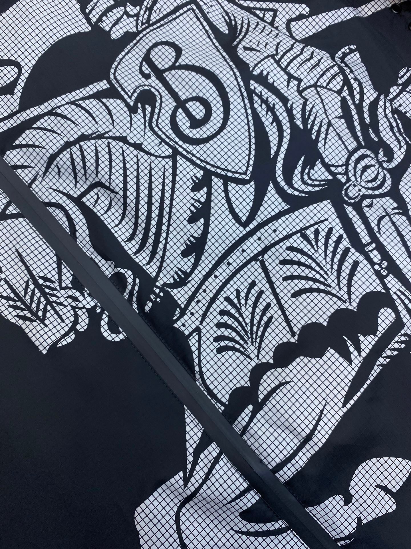 Hooded jacket graphic print close-up on dark fabric