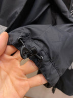 Hooded jacket cuff with drawstring toggle and black zipper tape