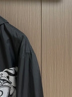 Black jacket sleeve and side panel with white graphic print