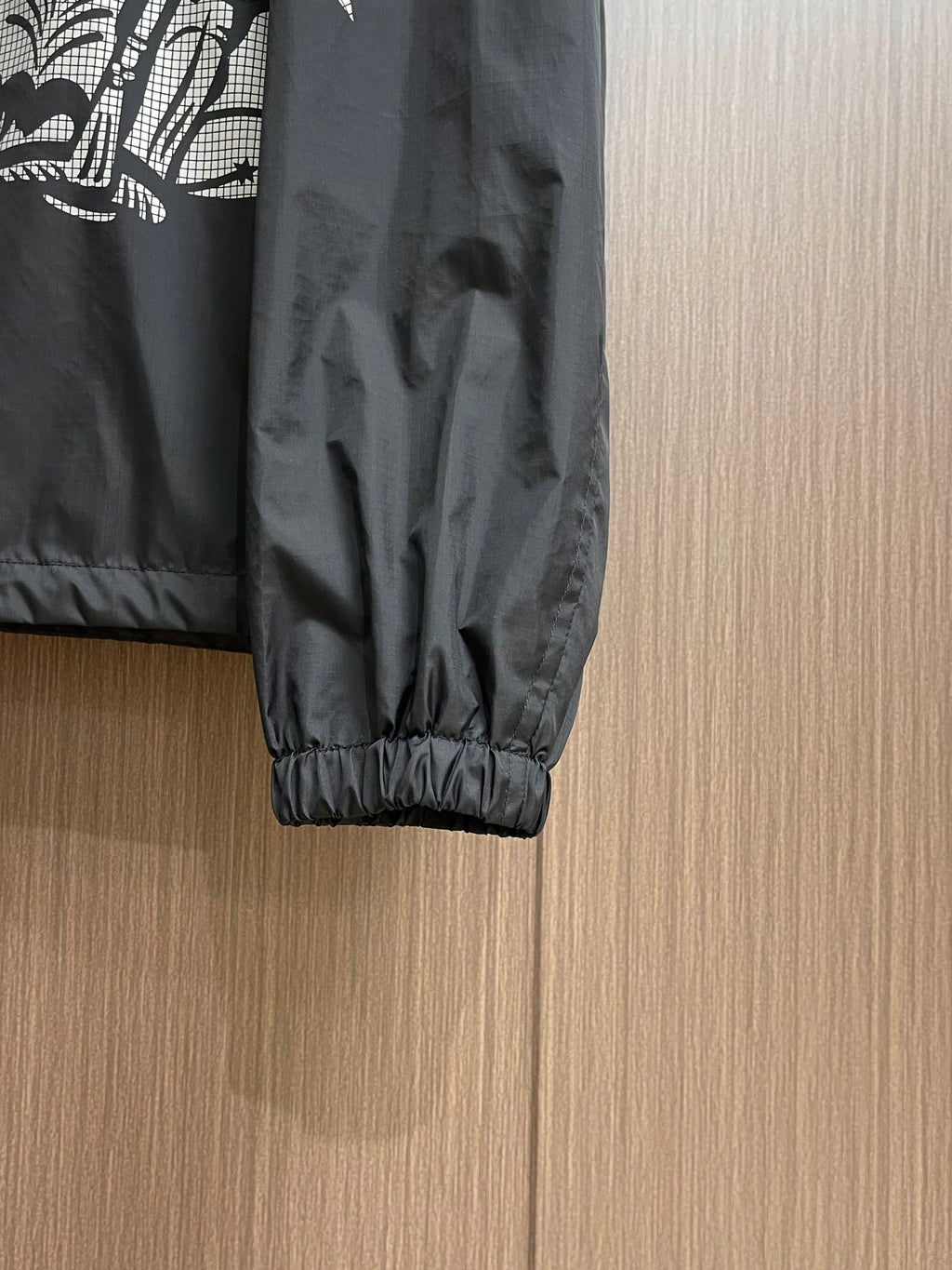 Black jacket sleeve with elastic cuff and gathered hem detail