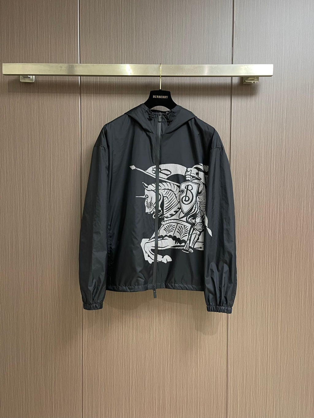 Black zip-up hooded jacket with bold white graphic print on chest