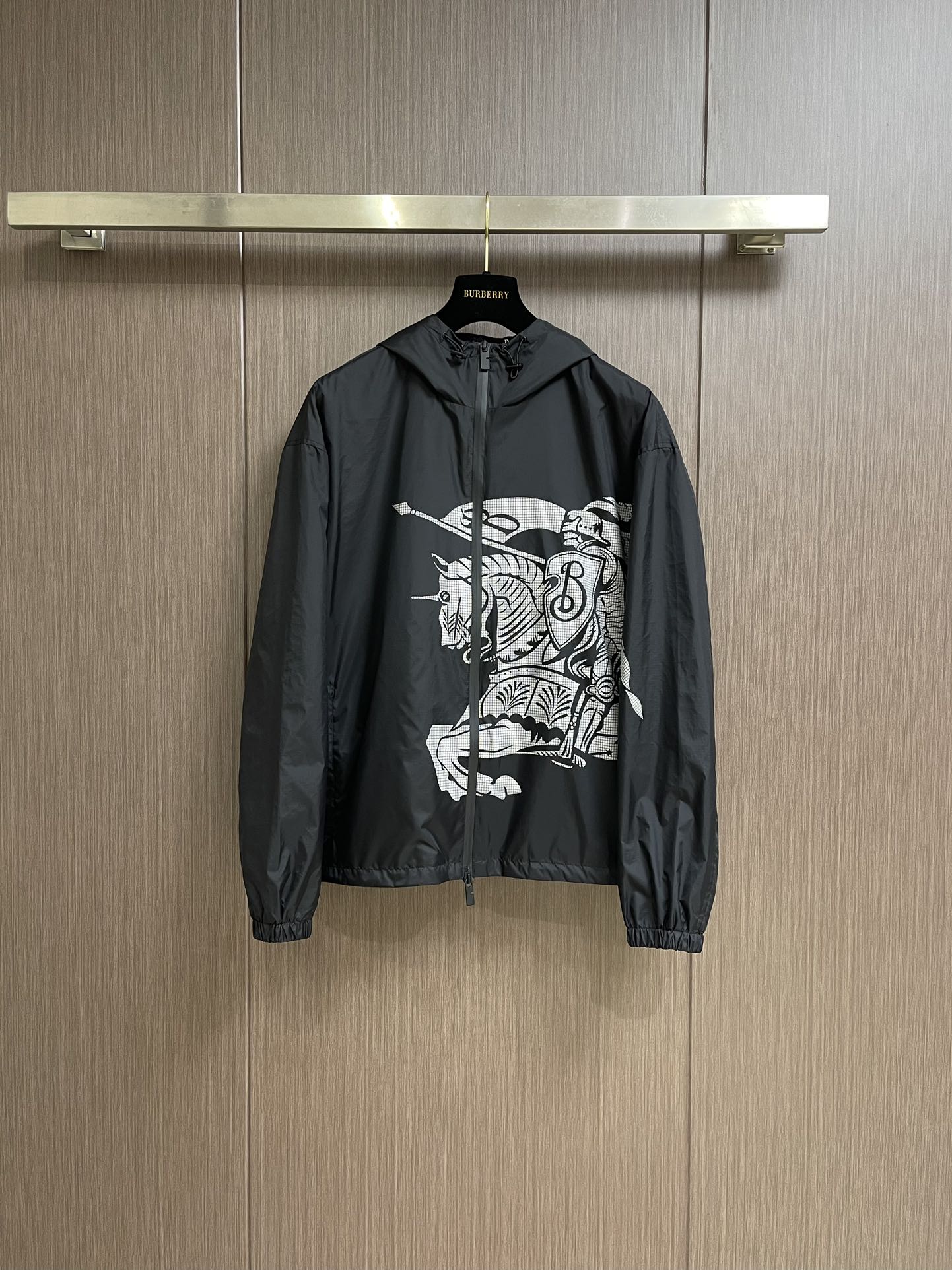 Black zip-up hooded jacket with bold white graphic print on chest