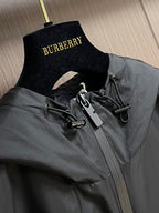 Black jacket neckline with hood detail and hanging inner label tag