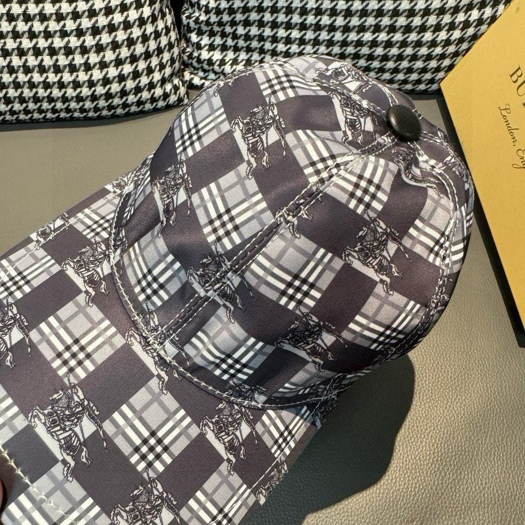 Burberry checkered cap close-up of side, showing black, white, and dark gray plaid stitching.