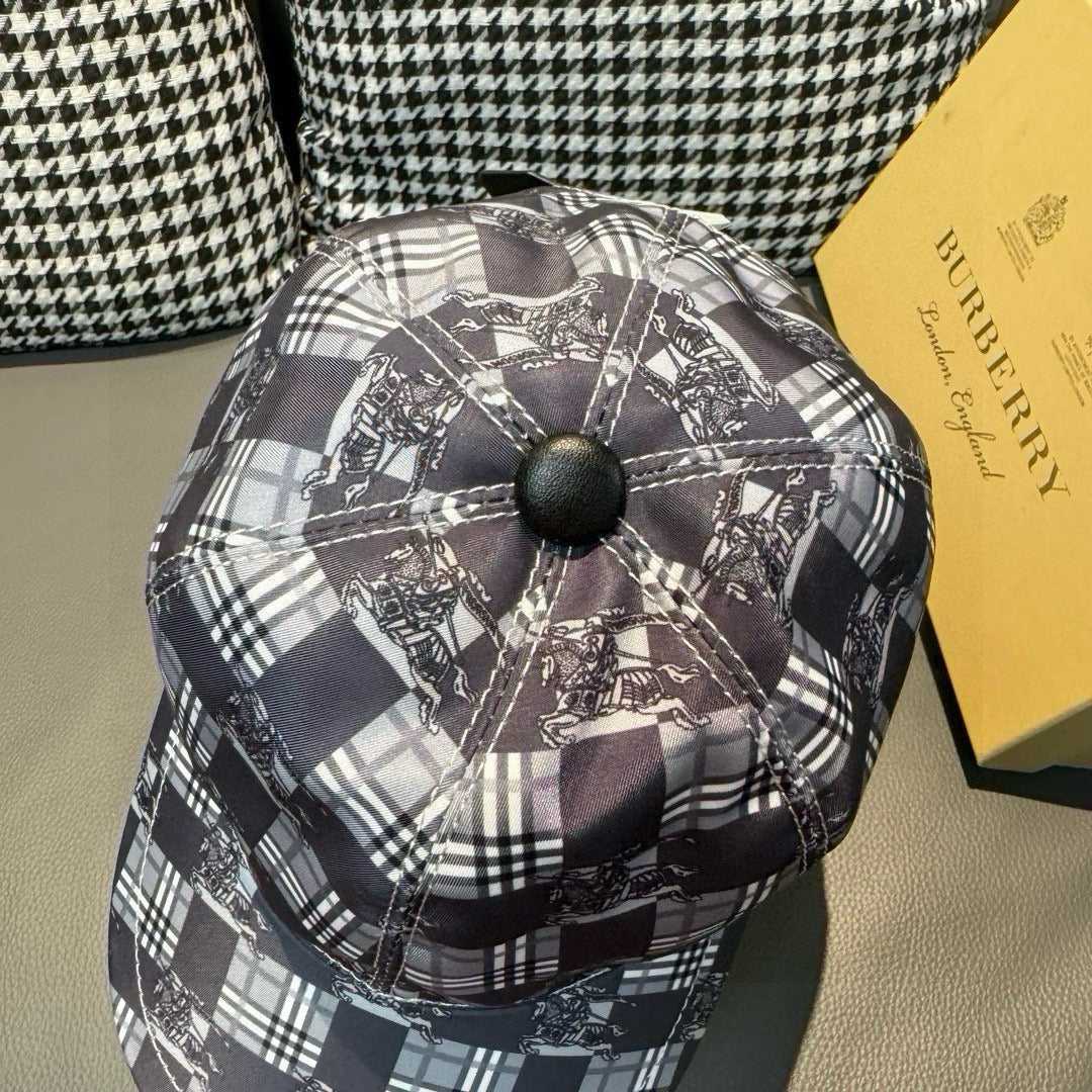 Burberry checkered cap close-up from top, black and white plaid with dark button center.