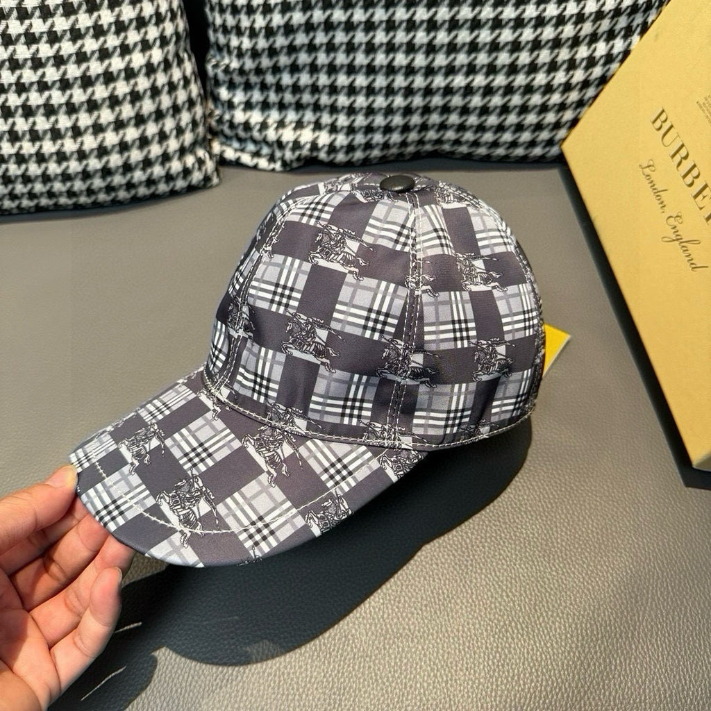 Burberry checkered cap held by hand, front view of black and white plaid fabric and brim.
