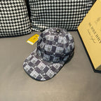 Burberry checkered cap with front panel and curved brim, black and white plaid pattern.