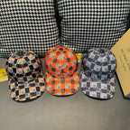 Three Burberry plaid caps: orange, black, and navy checkered styles with curved brims.