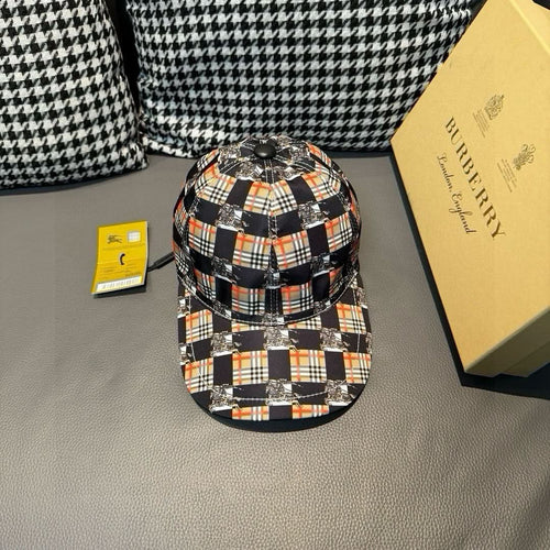 Burberry cap with black, white, orange, and red plaid panels and silver eyelets