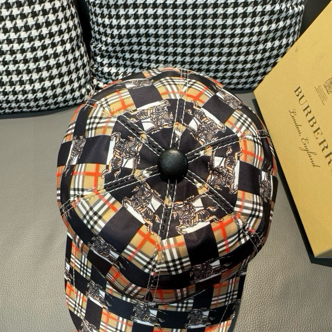 Burberry cap crown detail with black pinwheel pattern and multicolor plaid squares