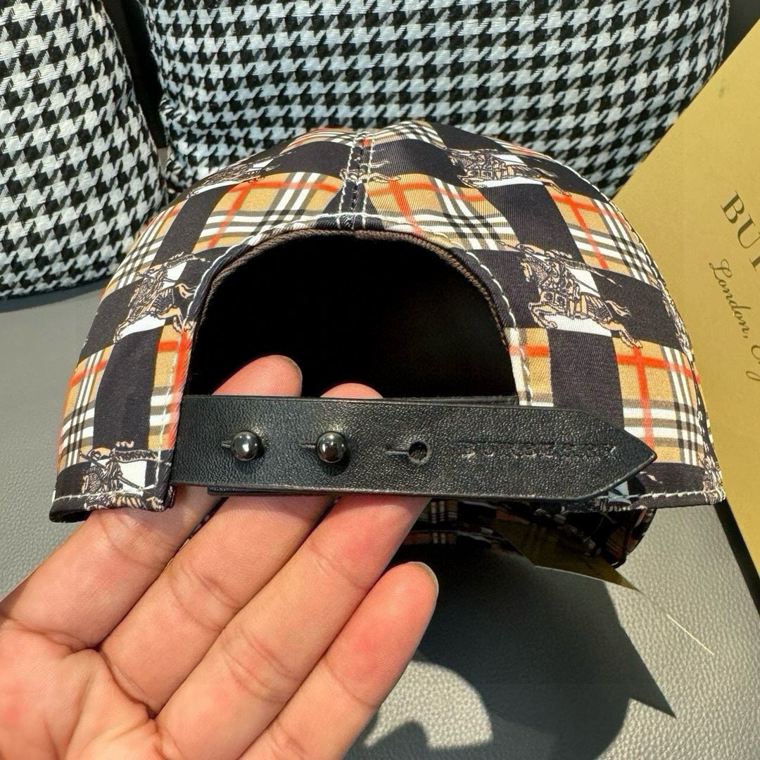 Burberry cap side detail with black strap and snap hardware, underside view