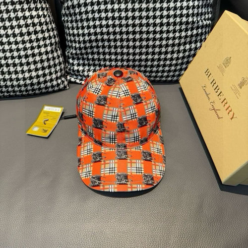 Orange plaid baseball cap with dark horse graphic and round eyelet on top