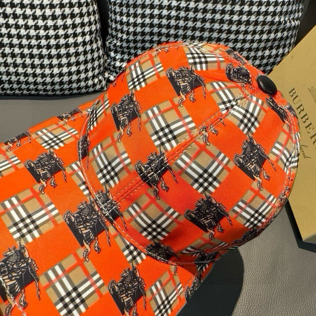 Orange plaid baseball cap close-up with dark horse graphics across the crown