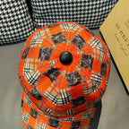 Orange plaid baseball cap top view with dark horse print and round button