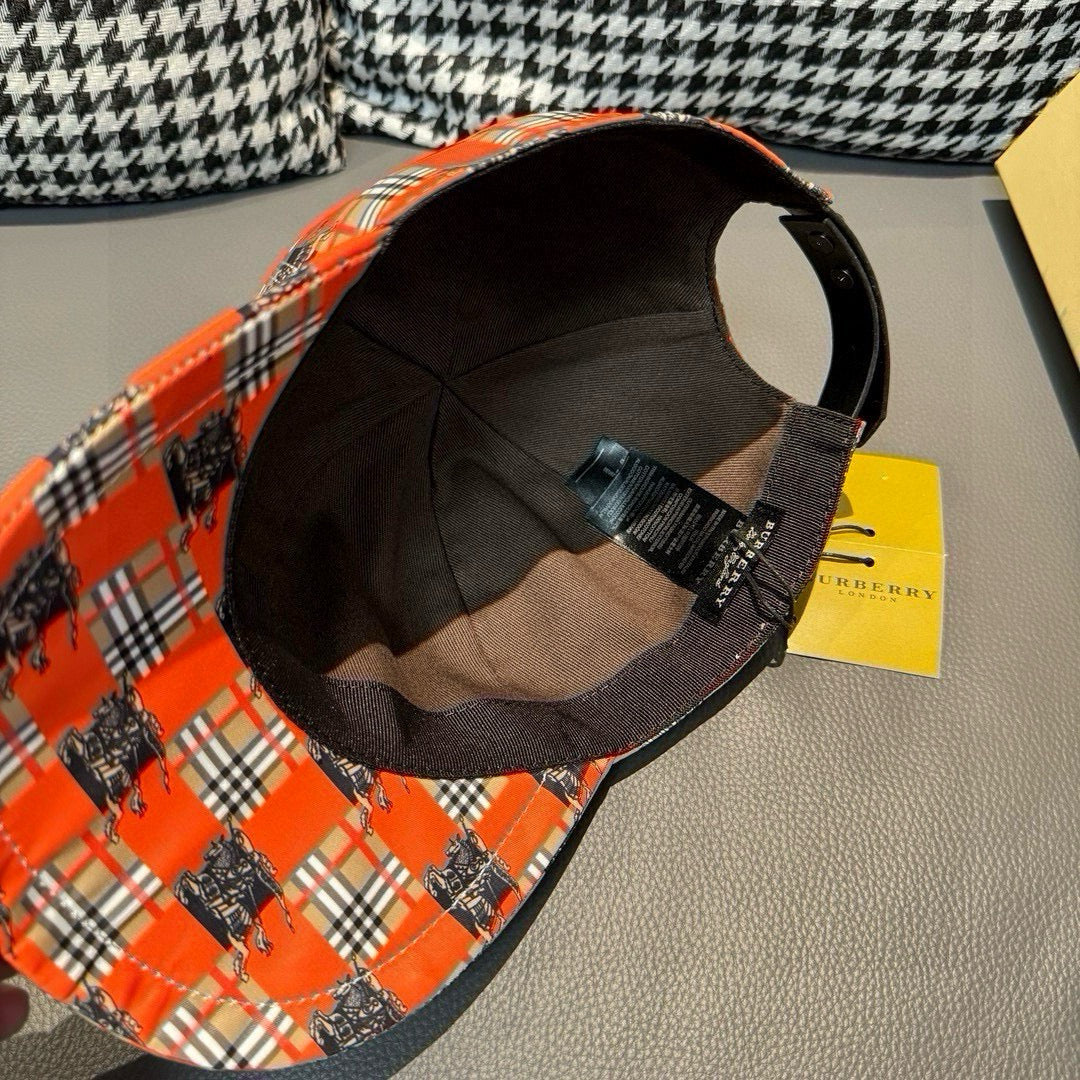 Orange plaid cap with black interior lining visible through the open crown