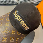 Louis Vuitton x Supreme cap close-up with black patch logo on brown monogram brim