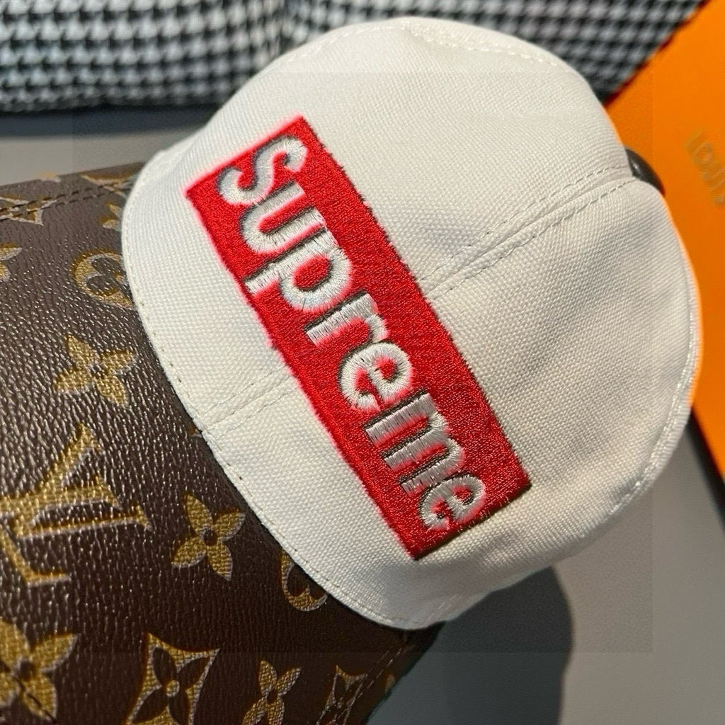 Louis Vuitton cap crown close-up, red Supreme logo patch on white fabric