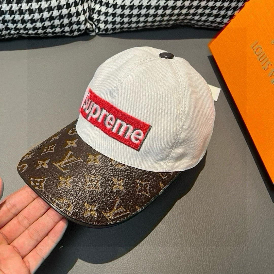 Louis Vuitton cap close-up with white crown and brown monogram brim, Supreme logo