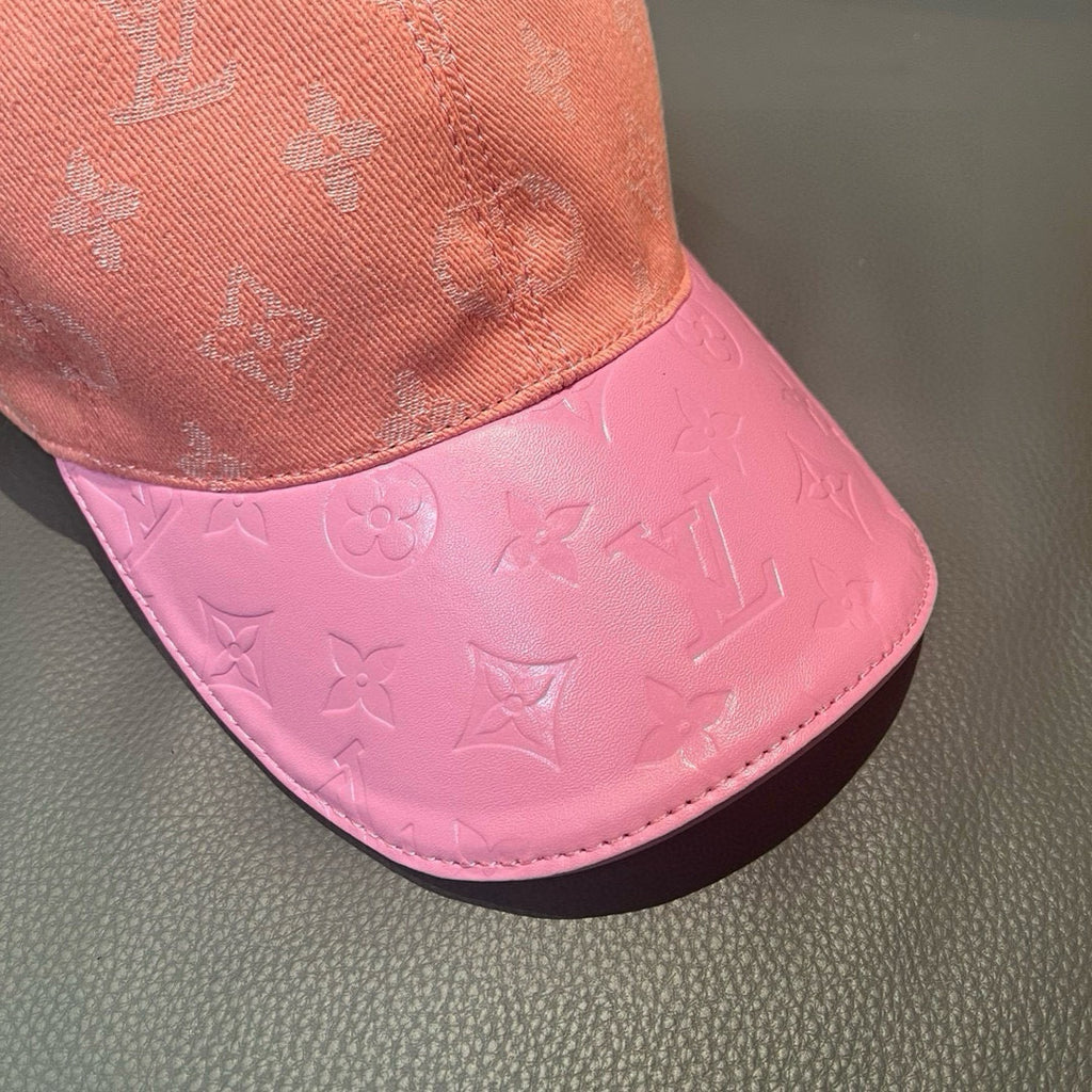 Louis Vuitton monogram baseball cap with pink brim panel under peach crown.