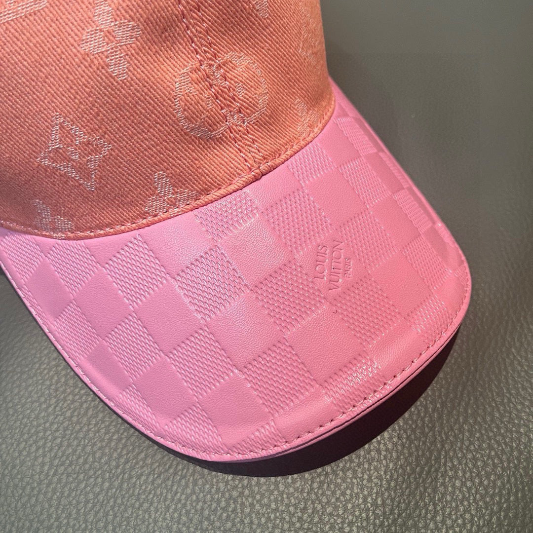 Louis Vuitton cap brim close-up in pink check pattern with small LV logo