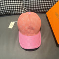 Louis Vuitton two-tone monogram cap with peach crown and pink checker brim