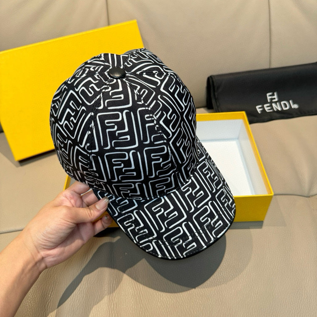 Black cap with white geometric pattern, held by hand at the crown