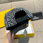 Black cap with white geometric pattern, front strap and side opening
