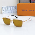 Louis Vuitton sunglasses with gold frame and amber tinted lenses, black temple tips.
