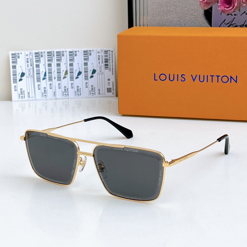 Louis Vuitton sunglasses with gold frame and dark gray tinted lenses, black temple tips.