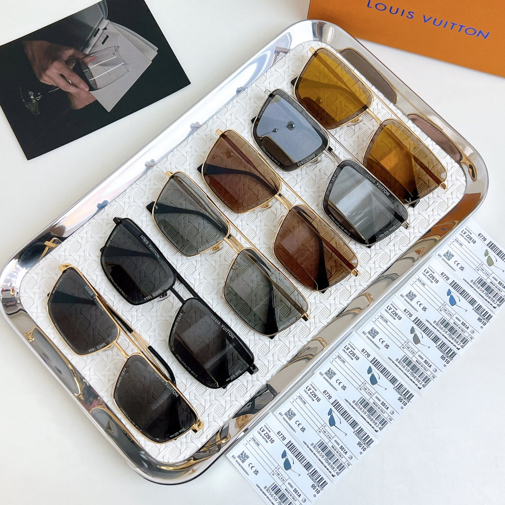 Louis Vuitton sunglasses assortment in display tray, various frame colors and tinted lenses.