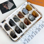 Louis Vuitton sunglasses assortment in display tray, various frame colors and tinted lenses.