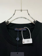 Black T-shirt neckline with drawcord and Louis Vuitton hang tags