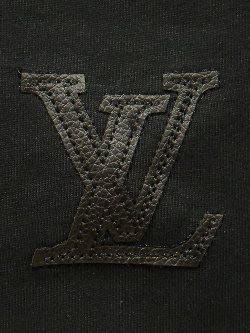 Black T-shirt with large embroidered Louis Vuitton-style LV monogram on chest