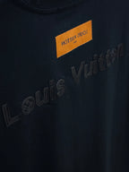 Black T-shirt with Louis Vuitton embossed lettering and orange label
