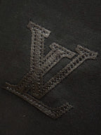 Black T-shirt with textured embroidered V logo