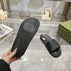 Black Gucci slide sandal outsole with textured tread and GUCCI crest