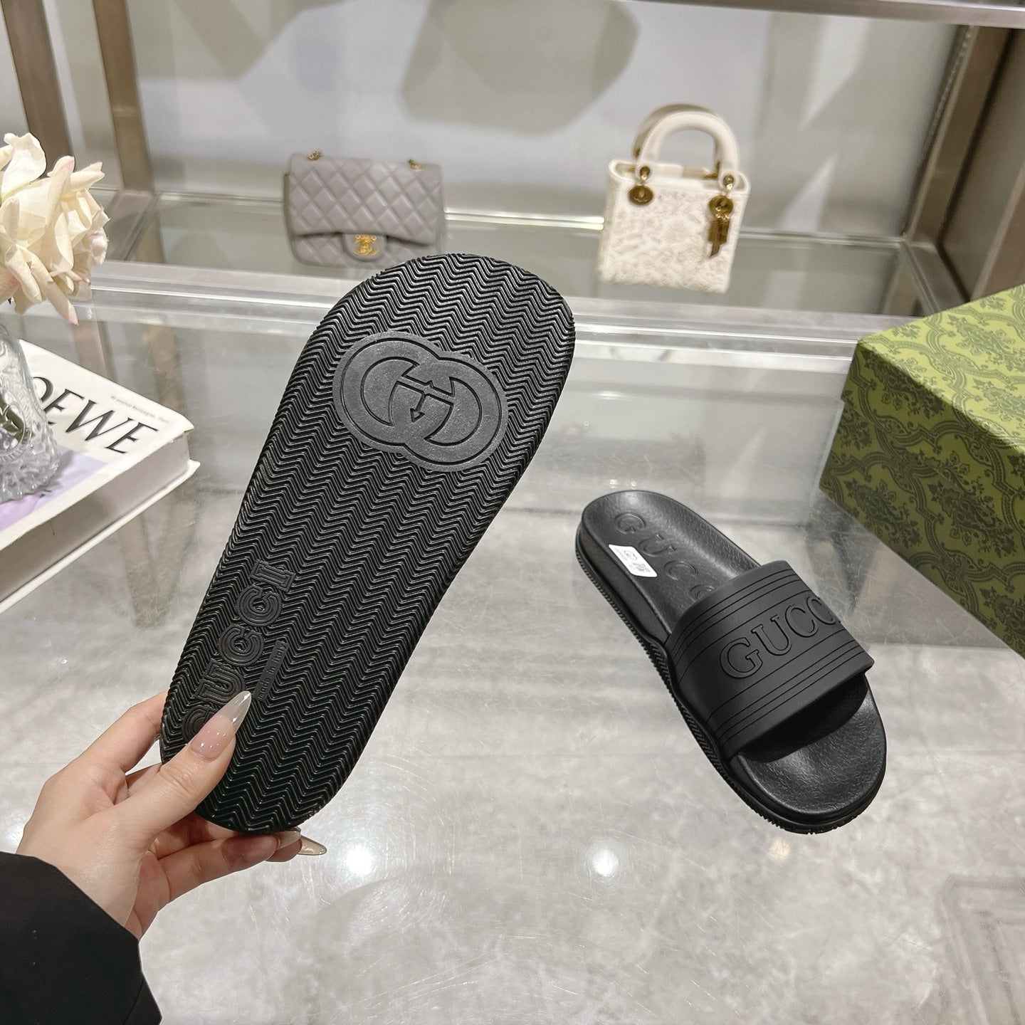 Black Gucci slide sandal outsole with textured tread and GUCCI crest