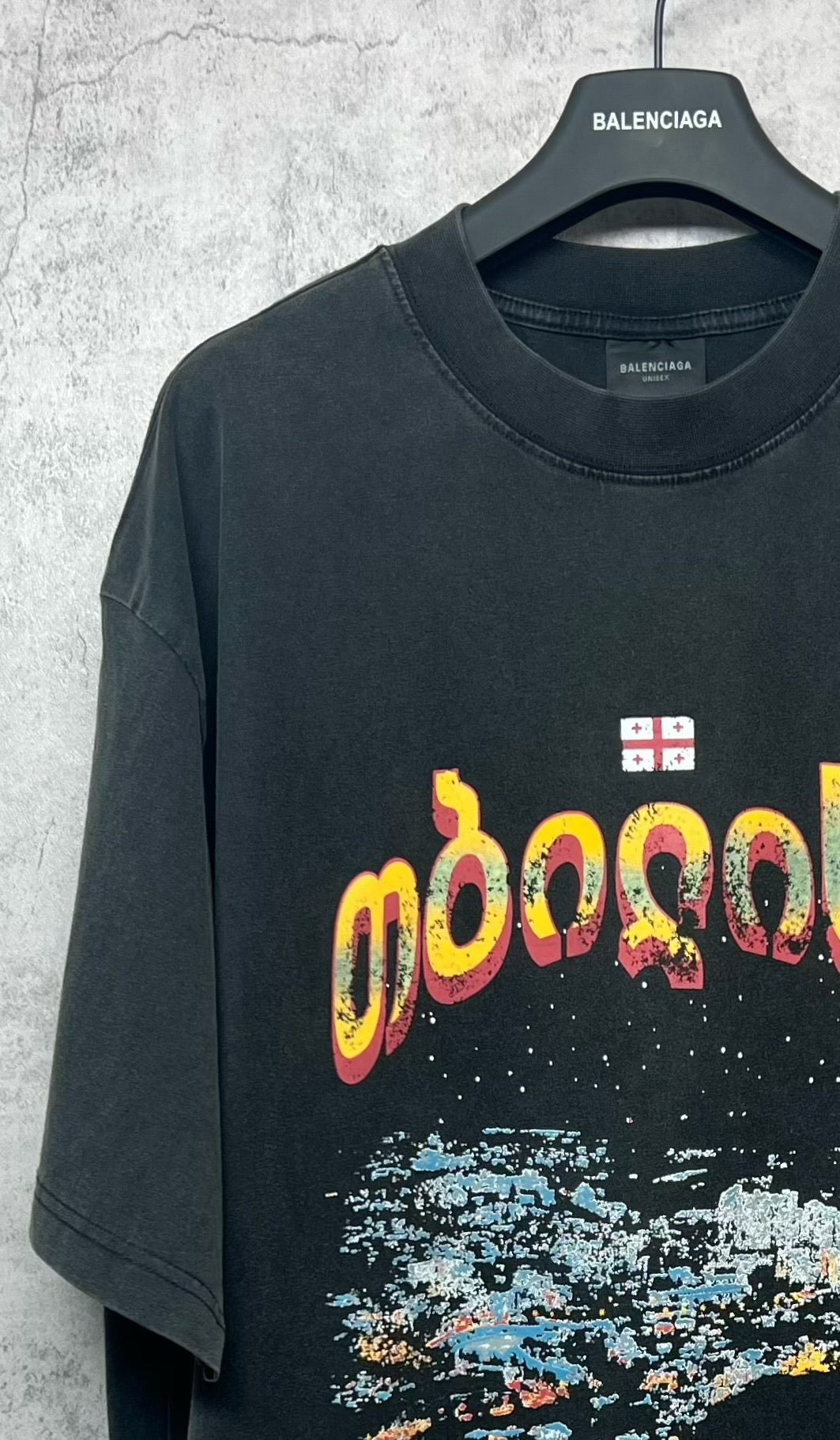 Dark gray crew-neck T-shirt with colorful front lettering graphic and paint-splash print