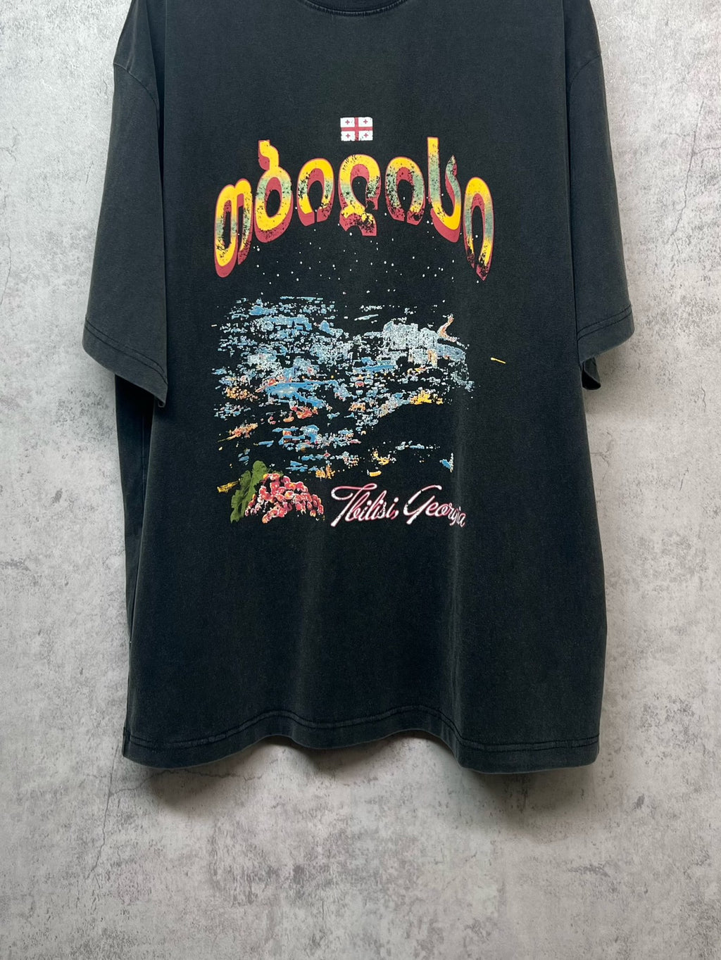 Dark gray crew-neck T-shirt with full colorful front graphic and abstract landscape print