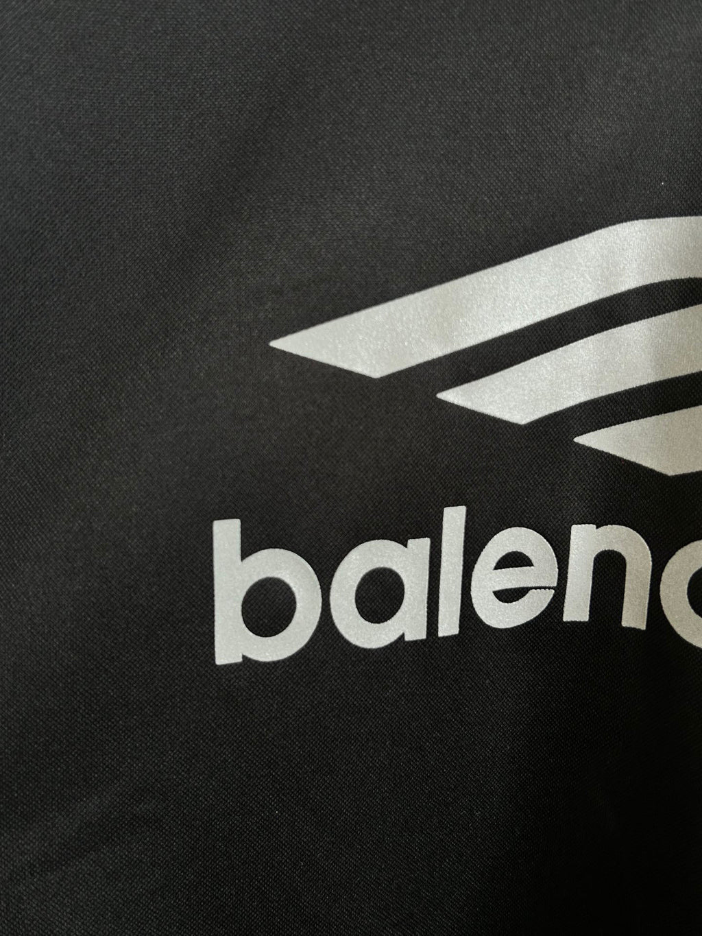 Balenciaga long-sleeve shirt close-up of white logo graphic and balenciaga text on black