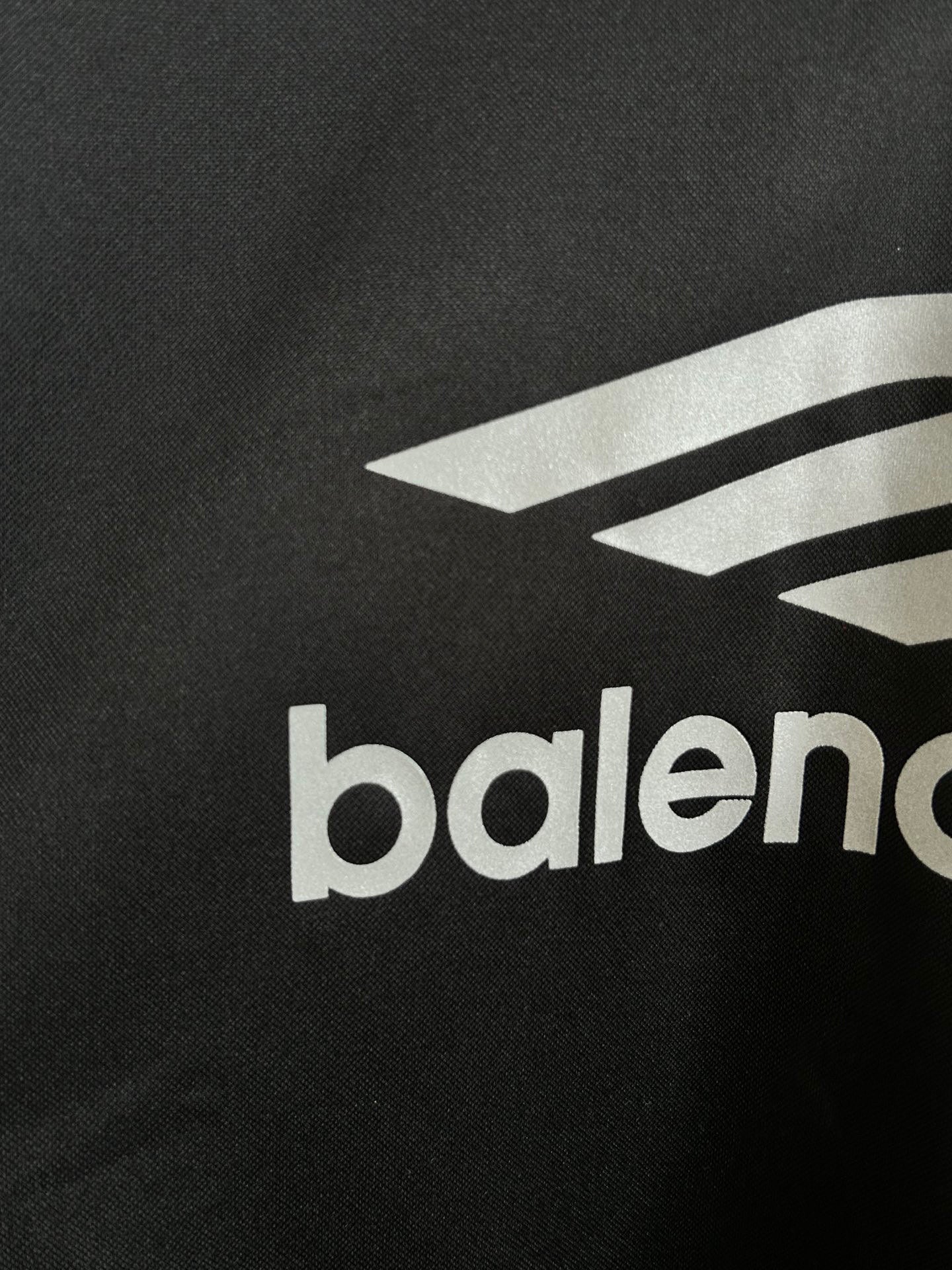 Balenciaga long-sleeve shirt close-up of white logo graphic and balenciaga text on black